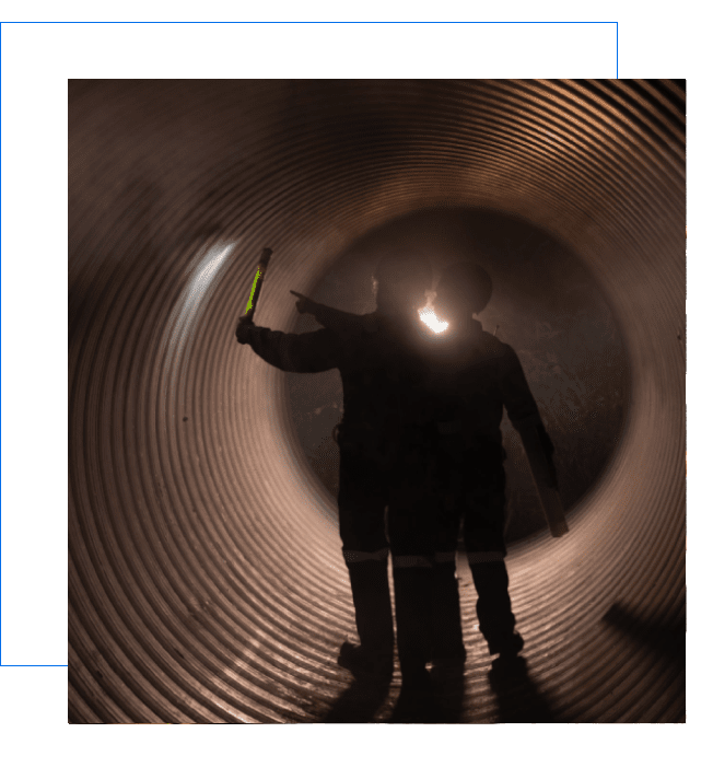 Shadows walking through an industrial tunnel