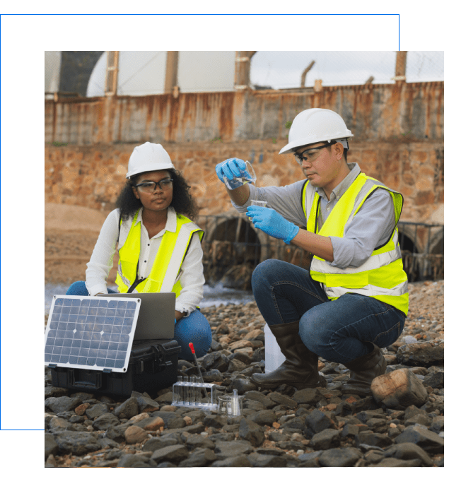 Environmental researchers analyzing samples by riverbank